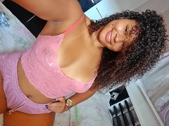 A brunette from Natal, RN, rolls around in her panties and bra, wiggling her huge butt in a home video