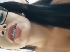 Delicious bronzed woman in braces rolls around in her panties and teases in amateur video