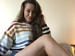 Delightful Porn Actress from the UK on all fours on the sofa, rolling her ass and showing her pussy