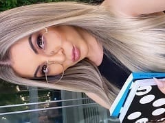 Influencer blonde in a short dress rolling around